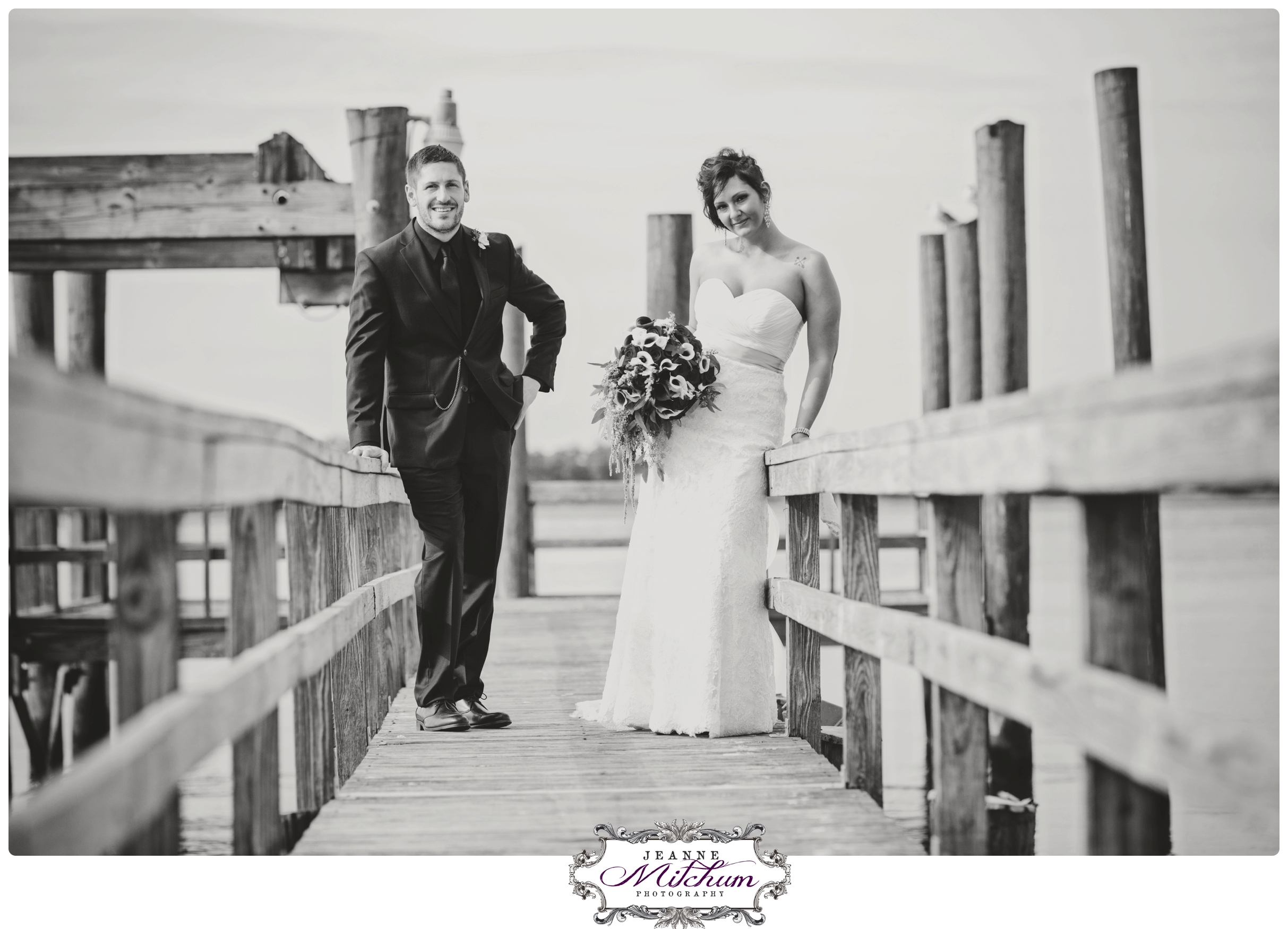 bride and groom on dock at island house
