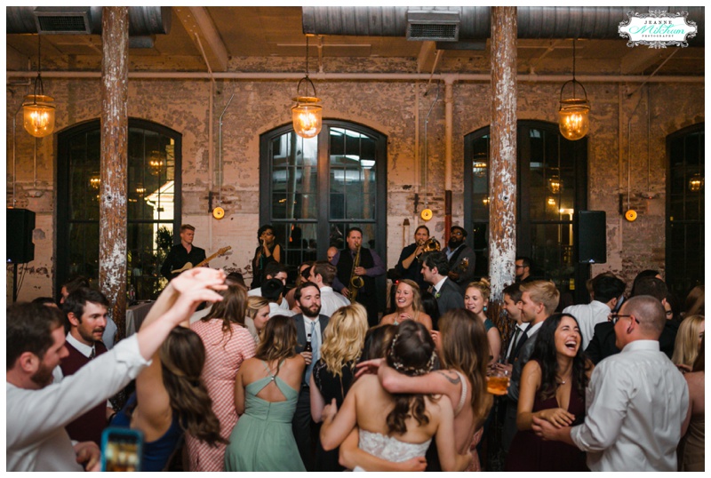people dancing at a wedding at the cedar room